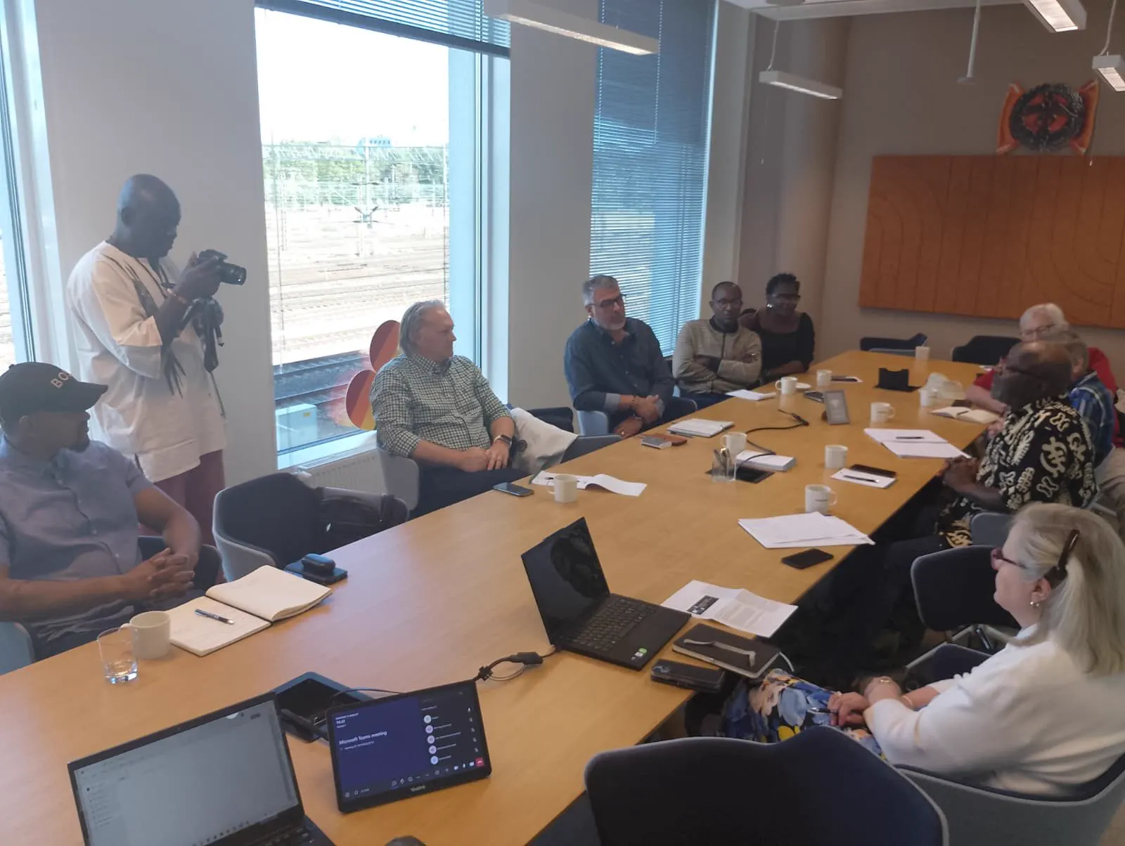 Sierra Leonean and Finnish participants holding bilateral discussions around a meeting table
